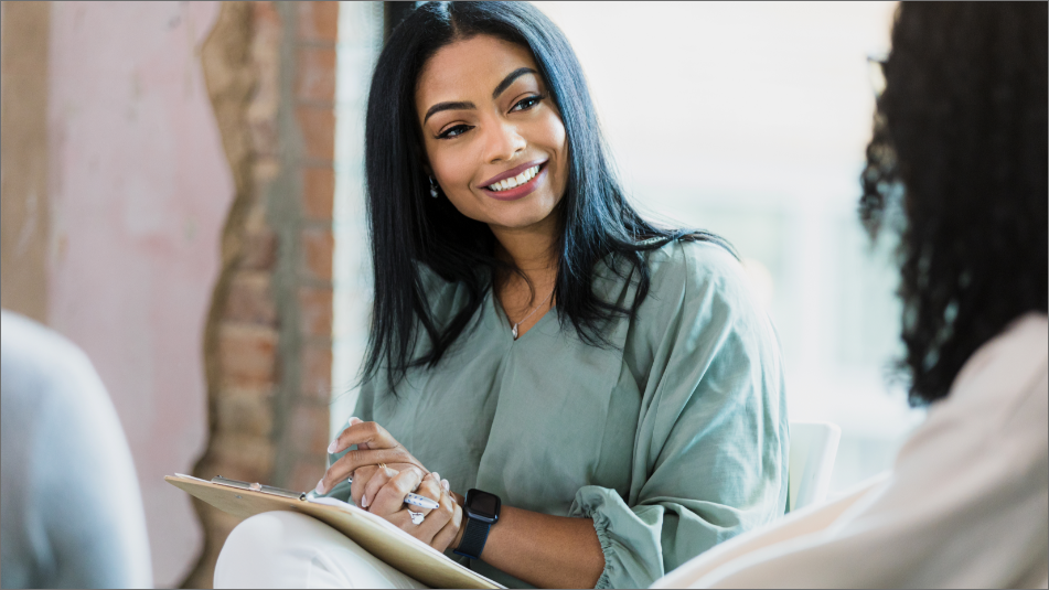 An Image of Real Estate Women Agent Talking to Client